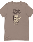 Flat lay of pebble Milk Sandwich T-shirt featuring Howdy CatBoy text and a vintage-style cowboy cat graphic with hat and bandana on white background