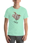 Man wearing a mint Milk Sandwich t-shirt with a smiling cartoon sloth hanging from a branch and the humorous phrase I farted below a small illustrated puff cloud.
