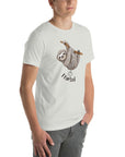 Side view of a man wearing a silver Milk Sandwich t-shirt featuring a playful cartoon sloth hanging from a branch with the phrase I farted and a small puff cloud illustration underneath.
