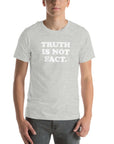 Unisex Milk Sandwich T-shirt featuring bold text "Truth is Not Fact" on a soft gray fabric, perfect for any casual outfit.