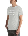 Unisex soft grey Milk Sandwich T-shirt displaying the phrase "Truth is Not Fact" in bold white letters, perfect for casual wear.