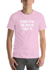 Unisex pink Milk Sandwich T-shirt with bold text "TRUTH IS NOT FACT", perfect for casual wear and everyday comfort.