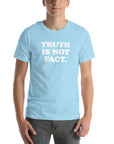 Light blue unisex Milk Sandwich T-shirt with the phrase "TRUTH IS NOT FACT" printed in bold white letters, showcasing comfort and style.