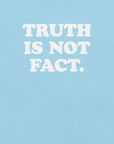 Close-up of ocean blue Milk Sandwich T-shirt with bold white text that reads Truth Is Not Fact, minimalist graphic tee with a bold statement.