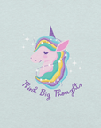 Close-up of a ice blue Milk Sandwich t-shirt with a pastel unicorn illustration and the phrase Think Big Thoughts in purple script, surrounded by sparkles.