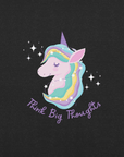 Close-up of a black Milk Sandwich t-shirt with a pastel unicorn illustration and the phrase Think Big Thoughts in purple script, surrounded by sparkles.