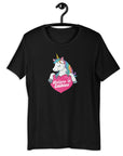 Black t-shirt on a hanger with a colorful unicorn graphic above a pink heart that says “Believe in Edibles.”