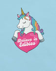 Ocean Blue of a colorful unicorn graphic holding a pink heart with the text “Believe in Edibles” on a light grey fabric background.