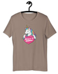 Pebble t-shirt on a hanger with a colorful unicorn graphic above a pink heart that says “Believe in Edibles.”