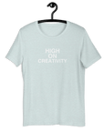 Ice Blue t-shirt on a hanger with the phrase “HIGH ON CREATIVITY” printed in white, centered on the chest.