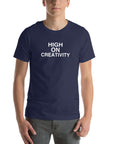Man wearing a navy t-shirt with the text ‘HIGH ON CREATIVITY’ in bold white capital letters, centered on the chest