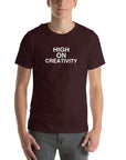Man wearing a oxblood black t-shirt with the text ‘HIGH ON CREATIVITY’ in bold white capital letters, centered on the chest