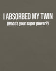 Close-up of army t-shirt with white text “I ABSORBED MY TWIN (What’s your super power?)” printed on the front.