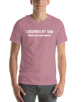 Man wearing orchid “I ABSORBED MY TWIN (What’s your super power?)” t-shirt, standing facing forward with hands relaxed.