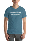 Man wearing teal “I ABSORBED MY TWIN (What’s your super power?)” t-shirt, standing facing forward with hands relaxed.