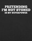 Close-up of black t-shirt with white text that says “PRETENDING I’M NOT STONED IS MY SUPERPOWER.”