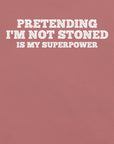 Close-up of mauve t-shirt with white text that says “PRETENDING I’M NOT STONED IS MY SUPERPOWER.”