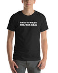 Man wearing black “THAT’S WHAT SHE/HER SAID” t-shirt, hands in pockets, looking relaxed to the front