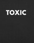 Close-up of black t-shirt with bold white “TOXIC” text printed on the front.