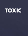 Close-up of navy t-shirt with bold white “TOXIC” text printed on the front.