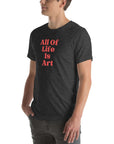 Side view of man wearing dark grey heather Milk Sandwich T-shirt with red All Of Life Is Art text, casual graphic tee with vintage-style typography.