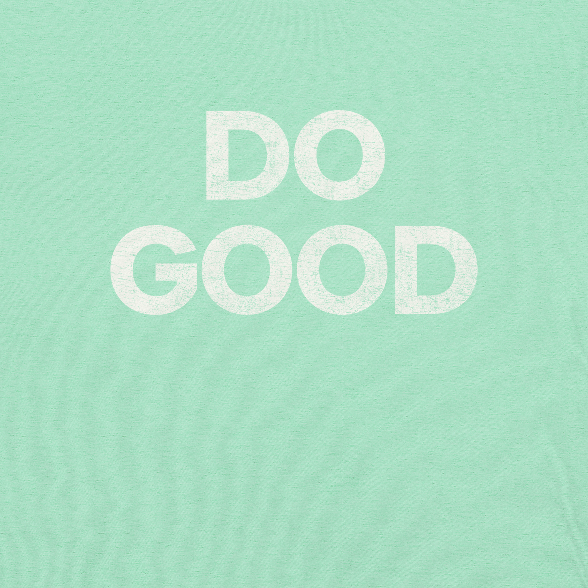 Close-up of mint Milk Sandwich T-shirt with bold distressed white text that reads DO GOOD, minimalist motivational graphic tee.