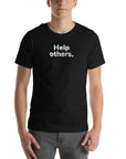 Front view of man wearing black Milk Sandwich T-shirt with faded white text that reads Help others. clean, minimalist message tee for everyday wear.