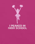 Close-up of berry Milk Sandwich T-shirt with distressed pink cheerleader graphic and white text that reads I Peaked in High School, sarcastic retro tee.