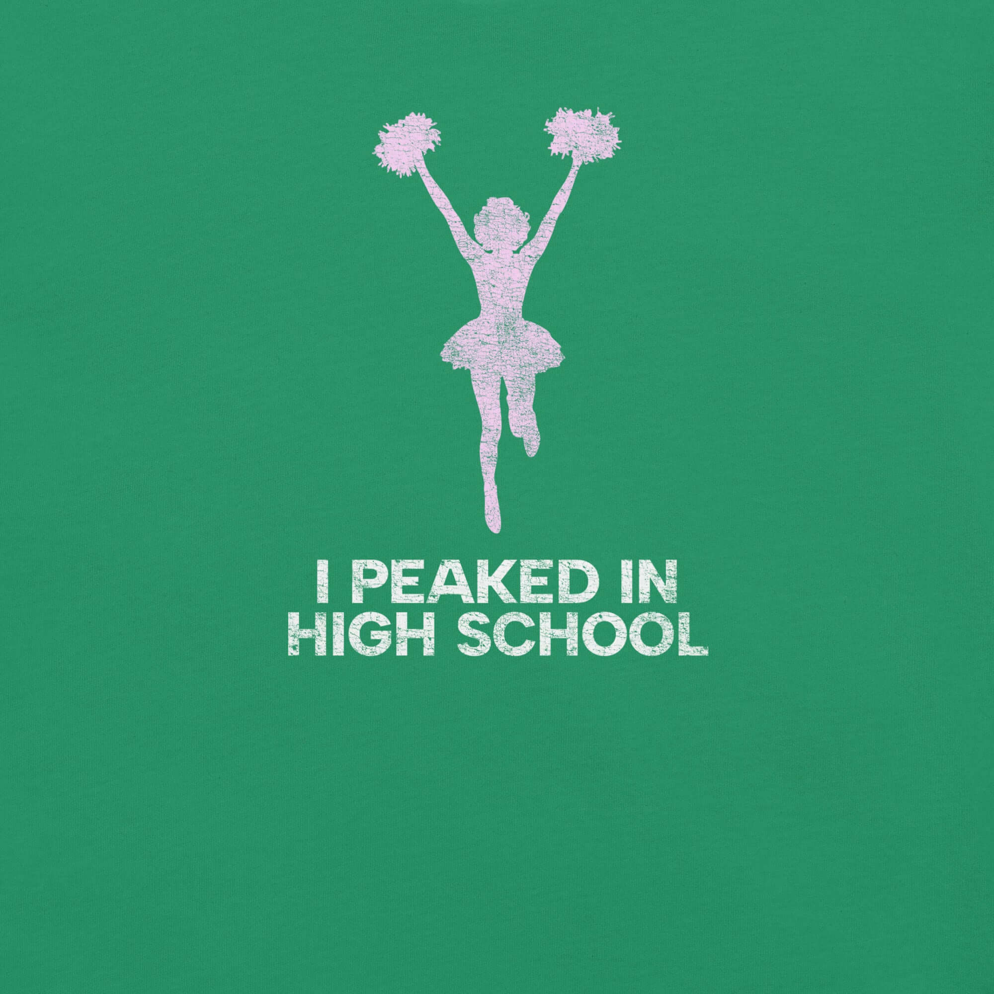 Close-up of green Milk Sandwich T-shirt with distressed pink cheerleader graphic and white text that reads I Peaked in High School, sarcastic retro tee.
