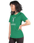 Model wearing a green unisex Milk Sandwich T-shirt that says "I Peaked in High School," showcasing its comfortable fit and fun design.