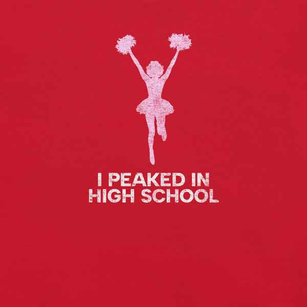 Close-up of red Milk Sandwich T-shirt with distressed pink cheerleader graphic and white text that reads I Peaked in High School,  sarcastic retro tee.