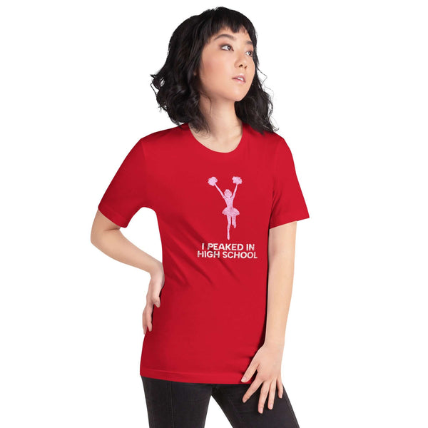 Soft red unisex Milk Sandwich T-shirt with "I Peaked in High School" graphic, perfect for nostalgia and fun fashion.