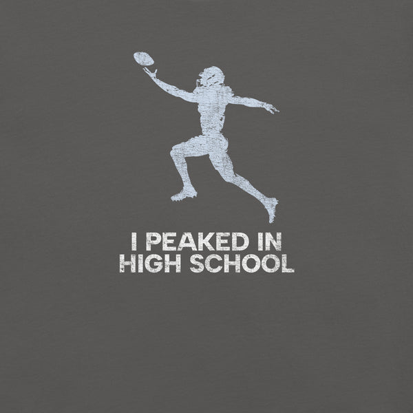 Close-up of asphalt Milk Sandwich T-shirt with distressed white football player graphic and text I Peaked in High School,  ironic athletic nostalgia tee.