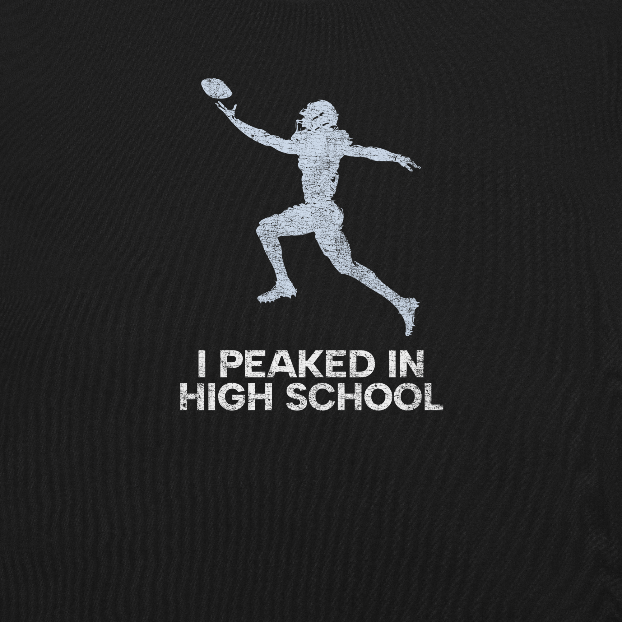Close-up of black Milk Sandwich T-shirt with distressed white football player graphic and text I Peaked in High School, ironic athletic nostalgia tee.