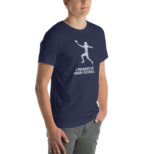 Unisex navy Milk Sandwich T-shirt with "I Peaked In High School" text and football graphic, perfect for sports enthusiasts and nostalgia lovers.