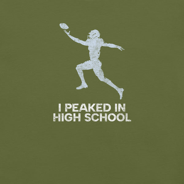 Close-up of olive Milk Sandwich T-shirt with distressed white football player graphic and text I Peaked in High School, ronic athletic nostalgia tee.