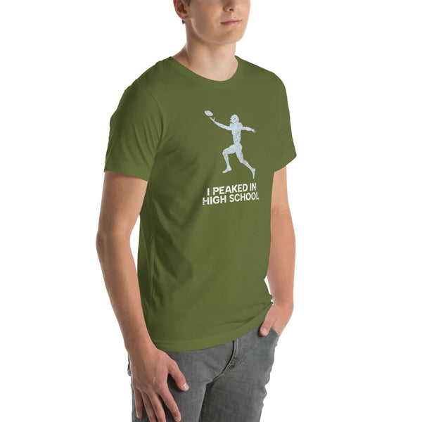 Man wearing an olive green "I Peaked in High School Football" Milk Sandwich T-shirt with a fun football graphic. Perfect for sports lovers!