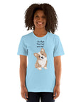Unisex light blue Milk Sandwich T-shirt with "I'm High, Can I Pet Your Dog?" and cute corgi design, worn by a smiling person.
