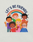 Close-up of a silver Milk Sandwich t-shirt with a colorful print showing six diverse cartoon children smiling and waving under a rainbow, with the text "LET'S BE FRIENDS" above them.