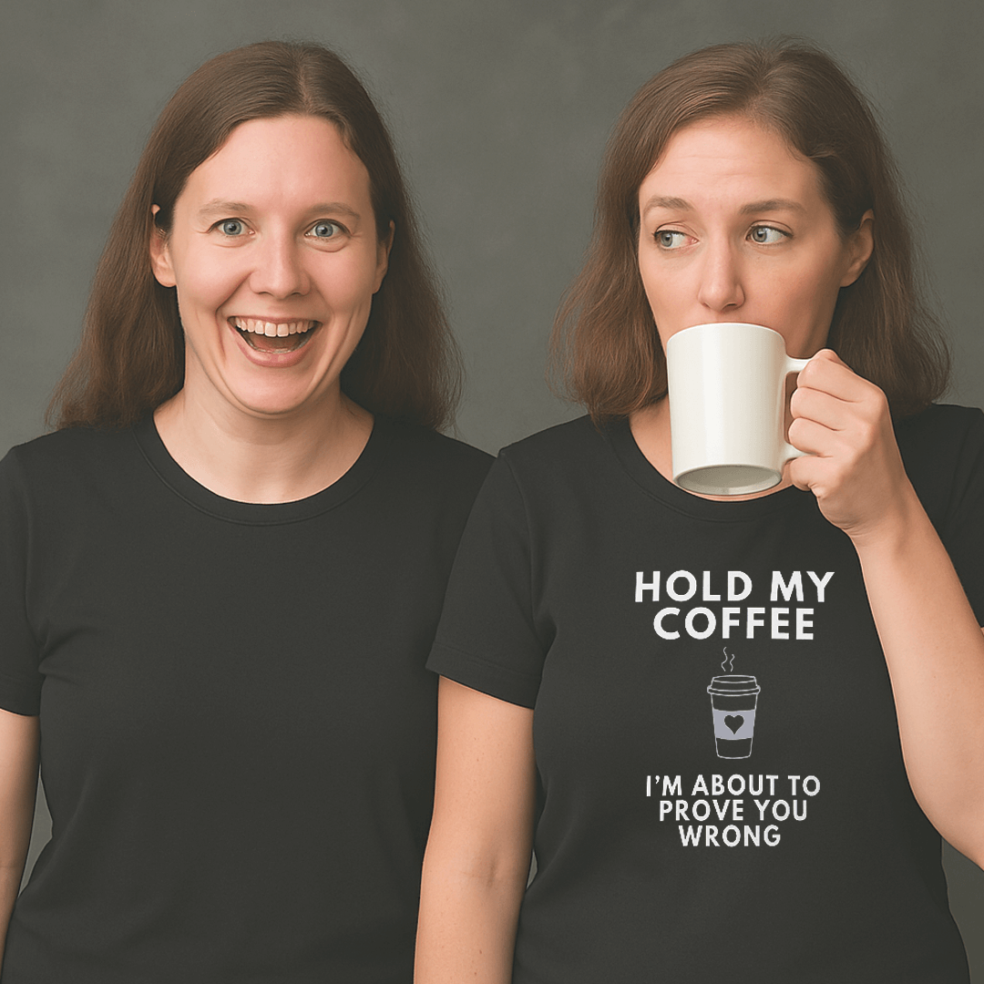 Two women wearing black t-shirts; one woman is smiling excitedly while the other drinks from a white mug and wears a shirt that says ‘Hold My Coffee I’m About To Prove You Wrong’ with a coffee cup graphic.