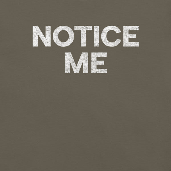 Close-up of a army Milk Sandwich t-shirt featuring bold white distressed text that reads NOTICE ME in all caps.