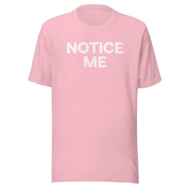 Front view of a pink Milk Sandwich t-shirt with bold distressed white text that says NOTICE ME in uppercase letters.