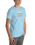 Angled front view of a man wearing a Milk Sandwich ocean blue t-shirt with a colorful distressed relax text design repeated vertically in white, blue, orange, and pink.