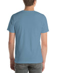 Back view of a person wearing a plain steel blue Milk Sandwich t-shirt with no visible design.