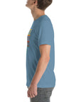 Side view of a person wearing a steel blue Milk Sandwich t-shirt featuring a colorful "Round Earth Society" design on the front.