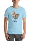 Man wearing a light blue Milk Sandwich t-shirt with a smiling cartoon sloth hanging from a branch and the humorous phrase I farted below a small illustrated puff cloud.