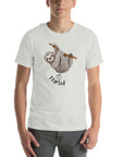 Man wearing a silver Milk Sandwich t-shirt with a smiling cartoon sloth hanging from a branch and the humorous phrase I farted below a small illustrated puff cloud.