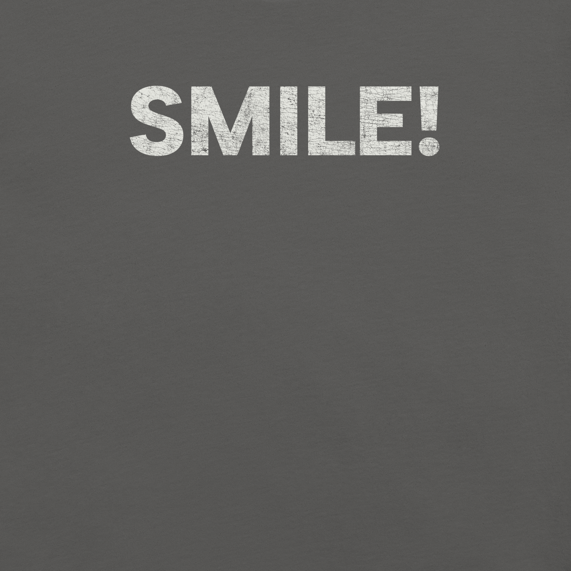 Close-up of a asphalt Milk Sandwich t-shirt with the word "SMILE!" printed in bold, distressed white text across the chest.