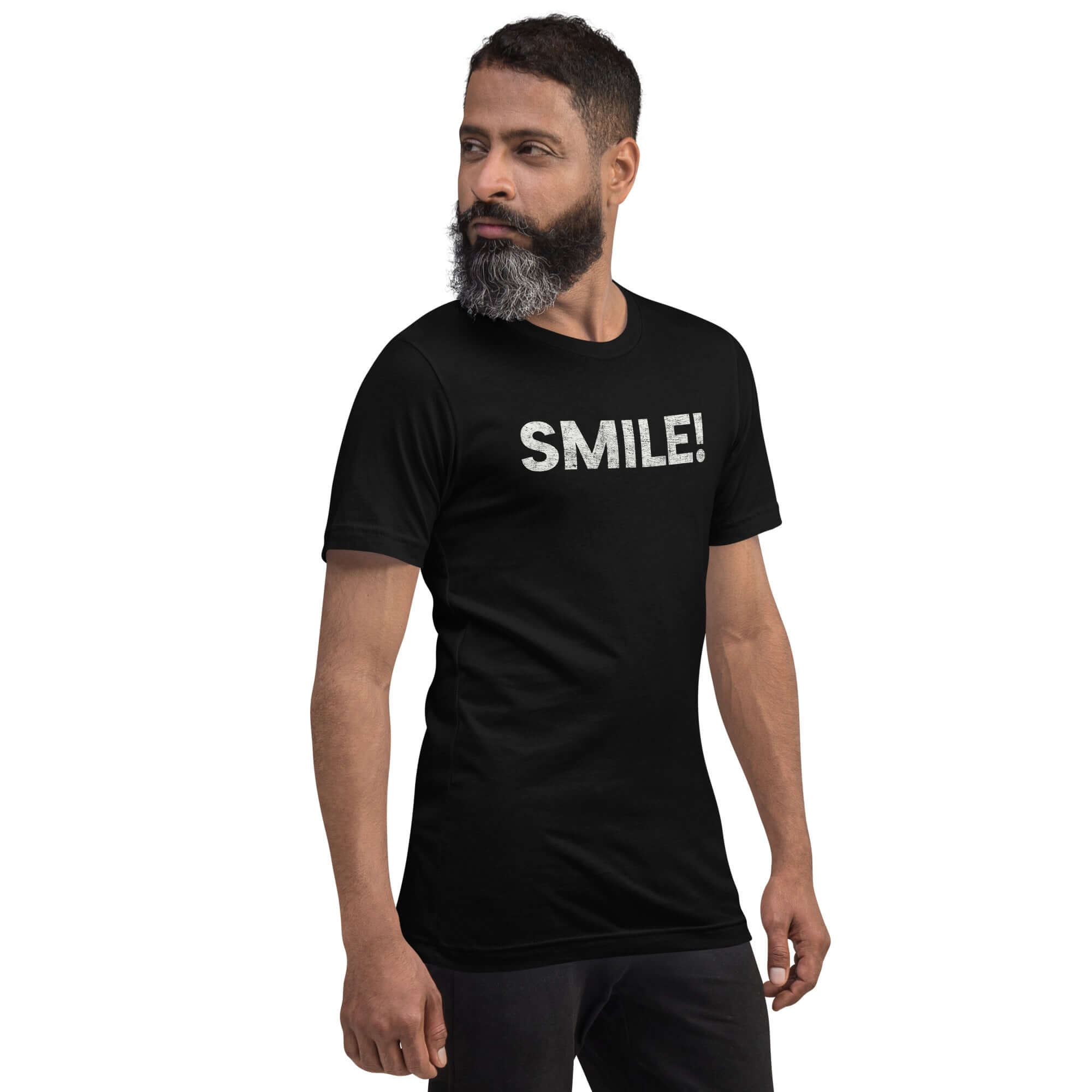 Side-facing man wearing a black Milk Sandwich t-shirt with distressed white text that reads SMILE! on the chest, set against a white backdrop.