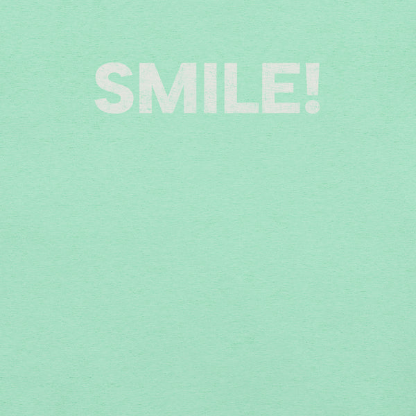 Close-up of heather mint Milk Sandwich t-shirt with the word "SMILE!" printed in bold, distressed white text across the chest.